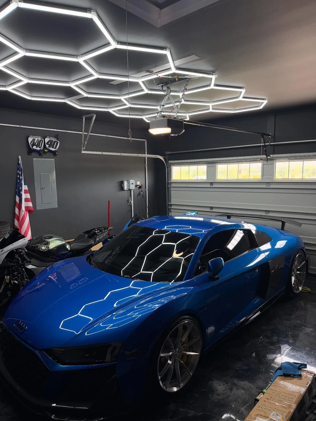 Blue Audi R8 in a garage under hexagon lighting