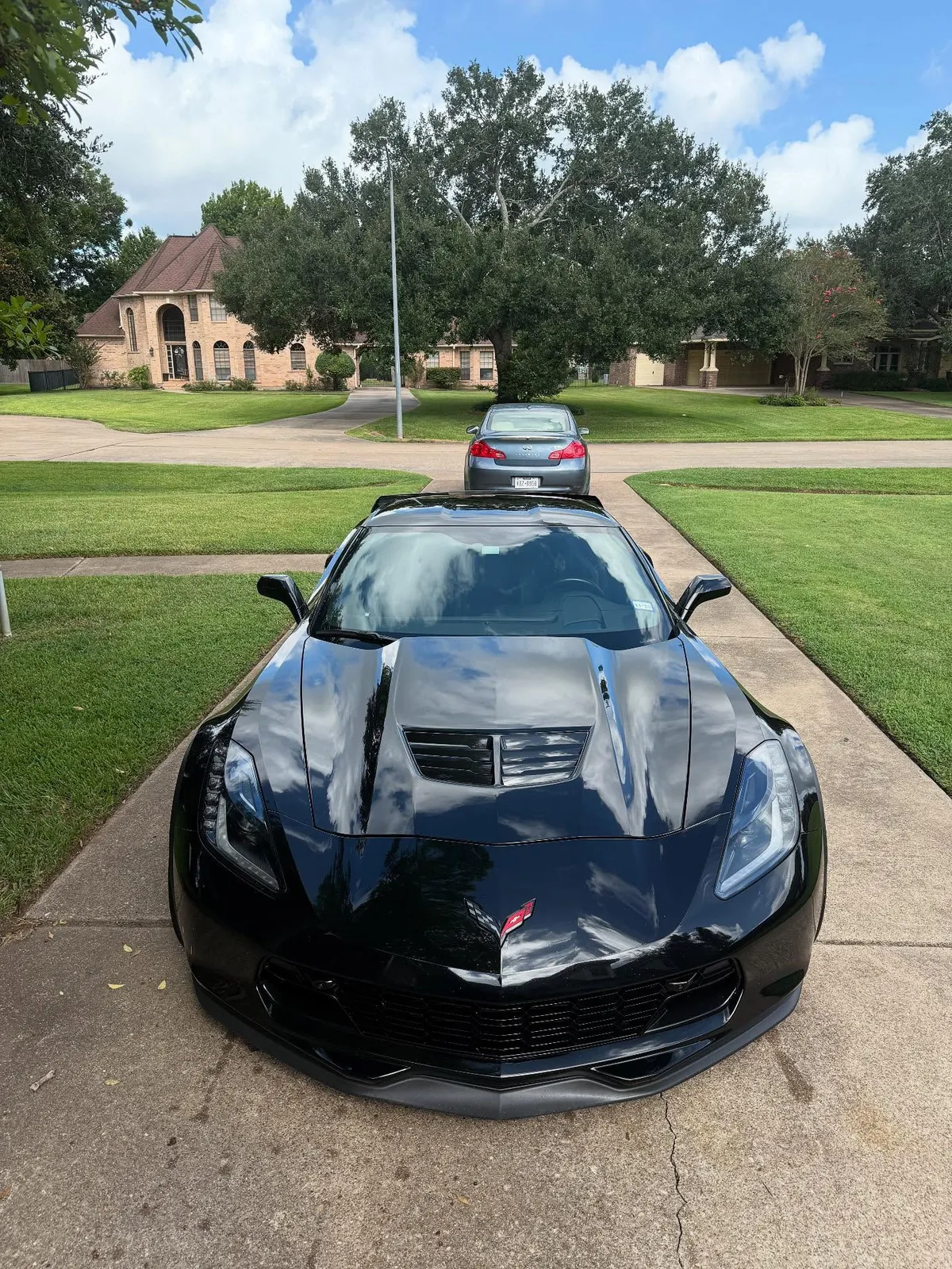 Mirror-finish hood on a black Corvette after paint correction