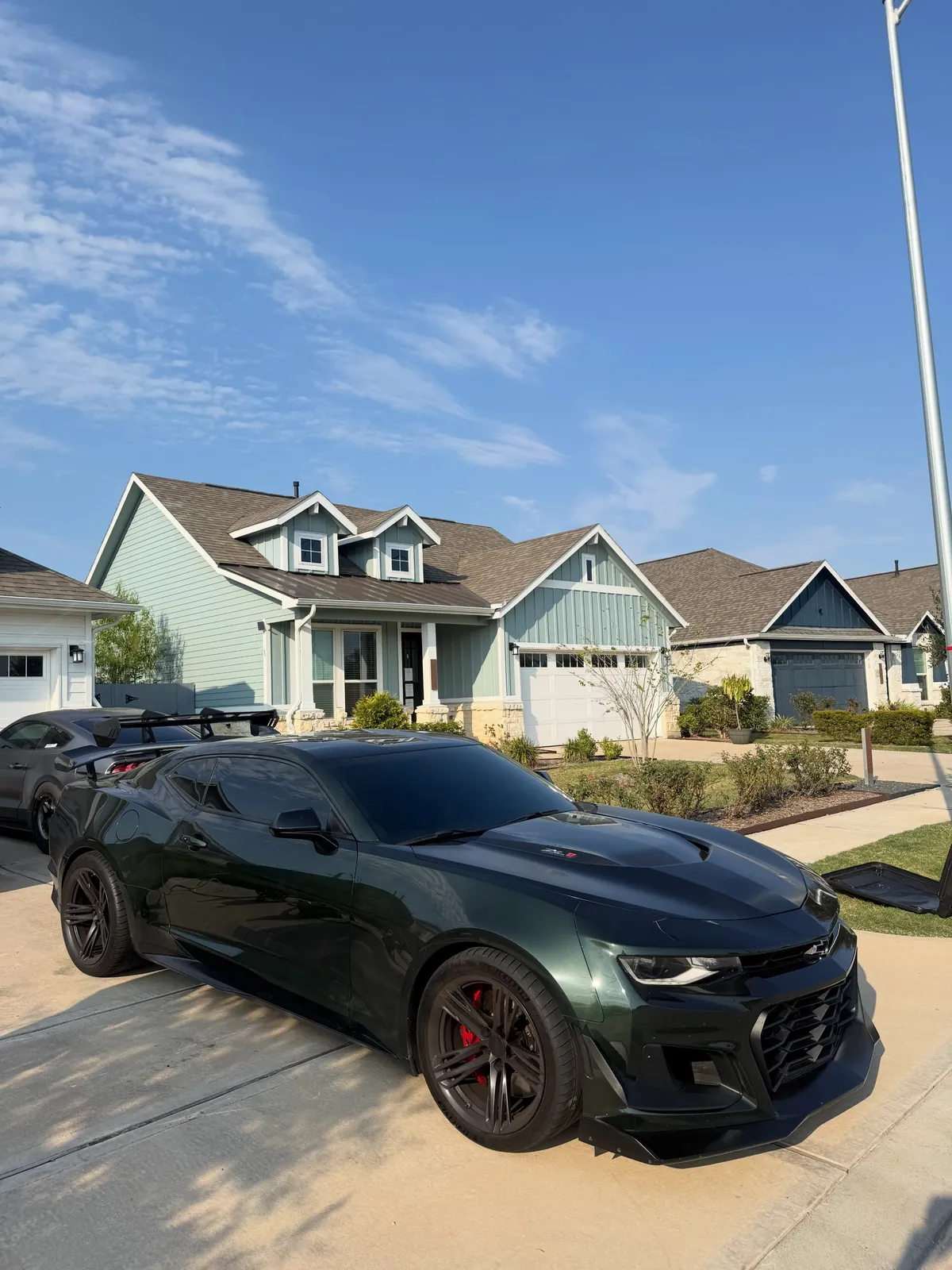 Green Chevrolet Camaro in a driveway