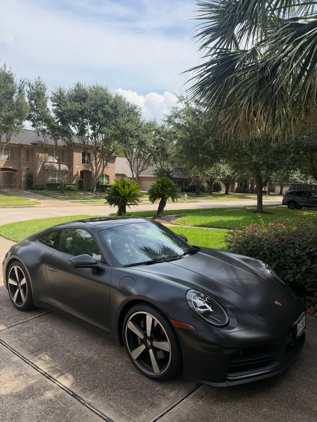 Matte grey Porsche 911 in a driveway